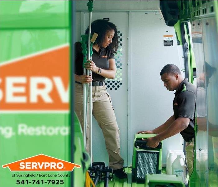SERVPRO technicians are loading equipment onto a service vehicle.